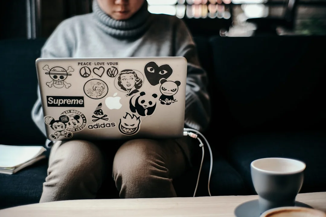 Focused business analysis with charts and graphs on a laptop in a modern office setting.